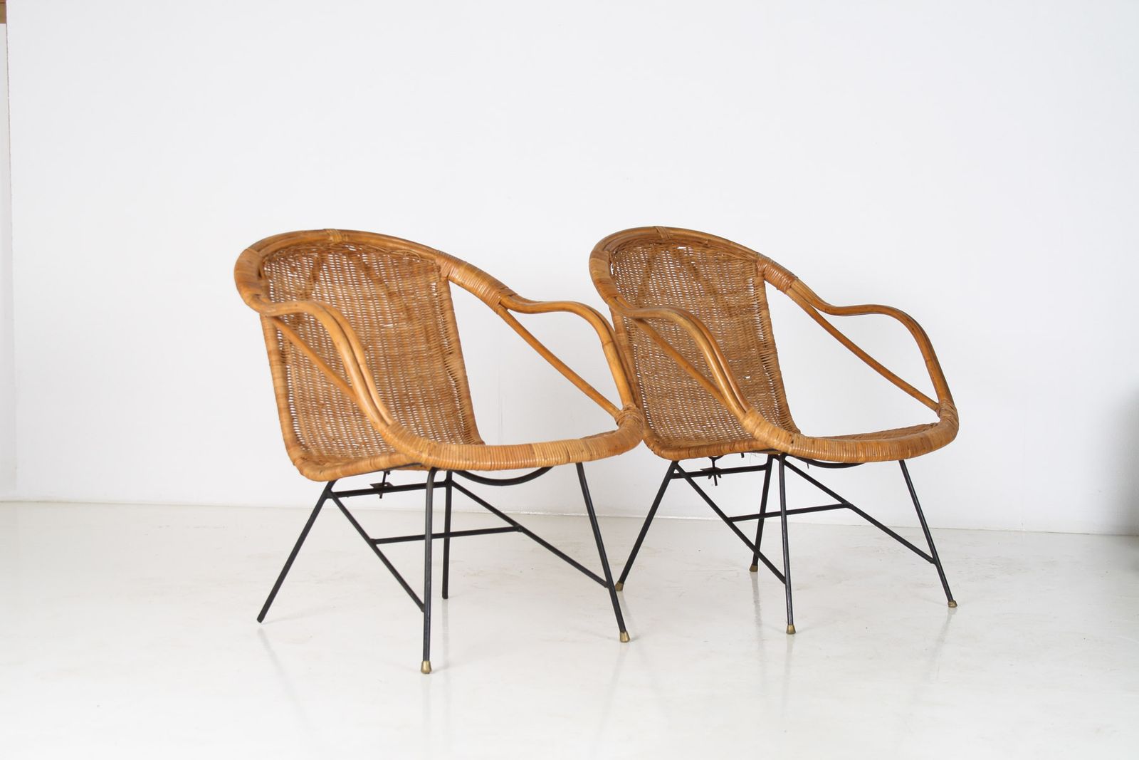 A Pair Of 1950s Mid Century Rattan Basket Chairs In The Manner Of Arthur Umanoff