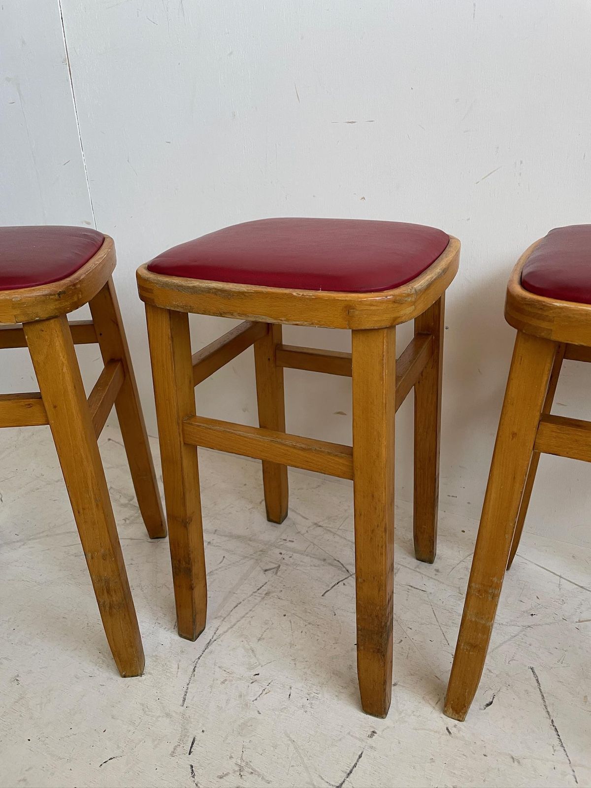 Set Of 3 Romanian Mid Century Wooden Stools With Red Vinyl Seats photo for sale