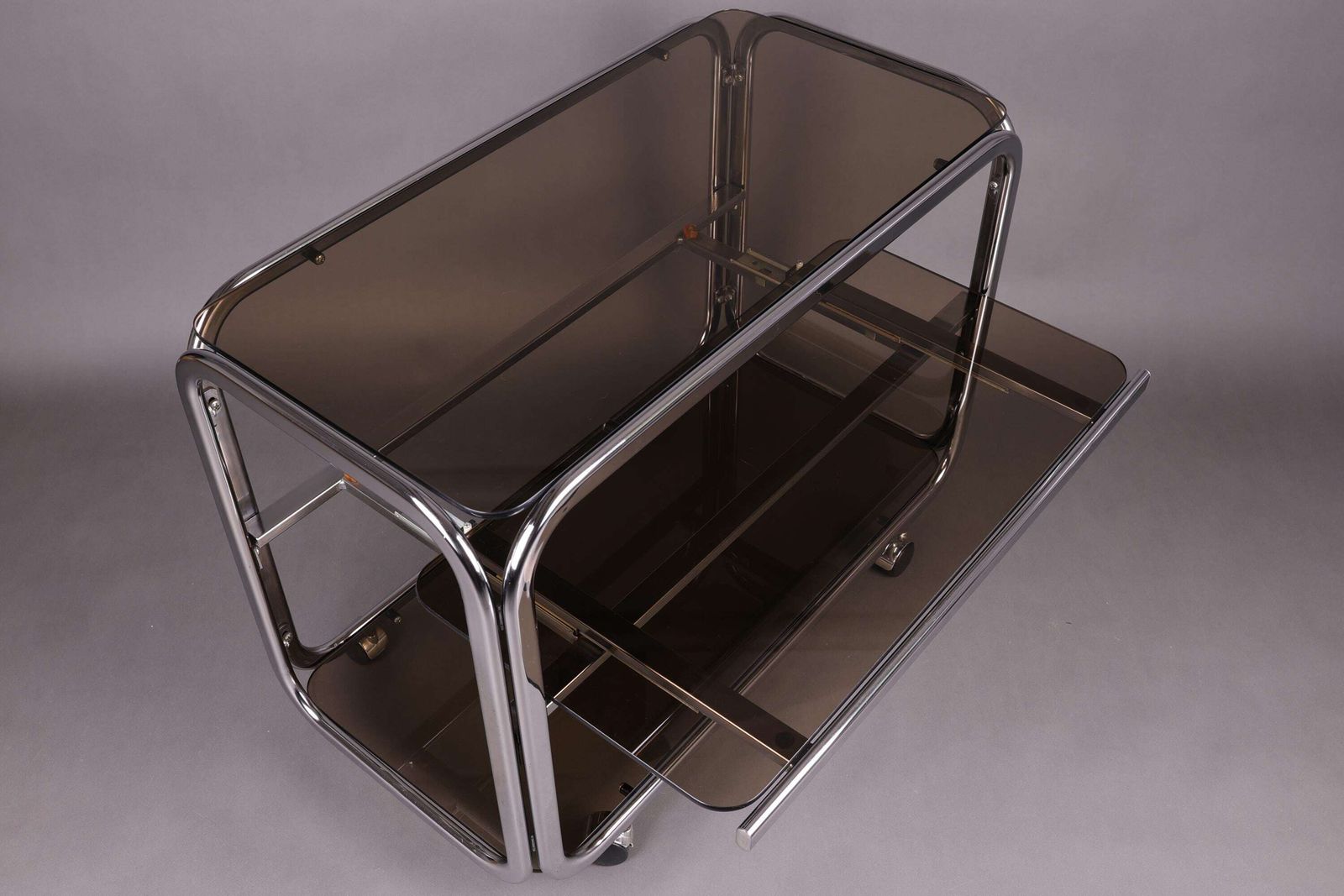 1970s Smoked Glass Side Table | Chrome Rolling Console | Vintage Mid Century Modern Trolley | Vintage Glam Accent Table For Living Room photo for sale