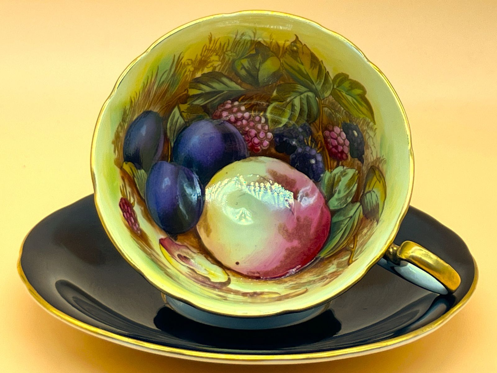 Aynsley China Orchard Gold Fruit Signed D Jones High Doris Shape Black And Gold Cabinet Tea Cup & Saucer Duo. C1952 63.