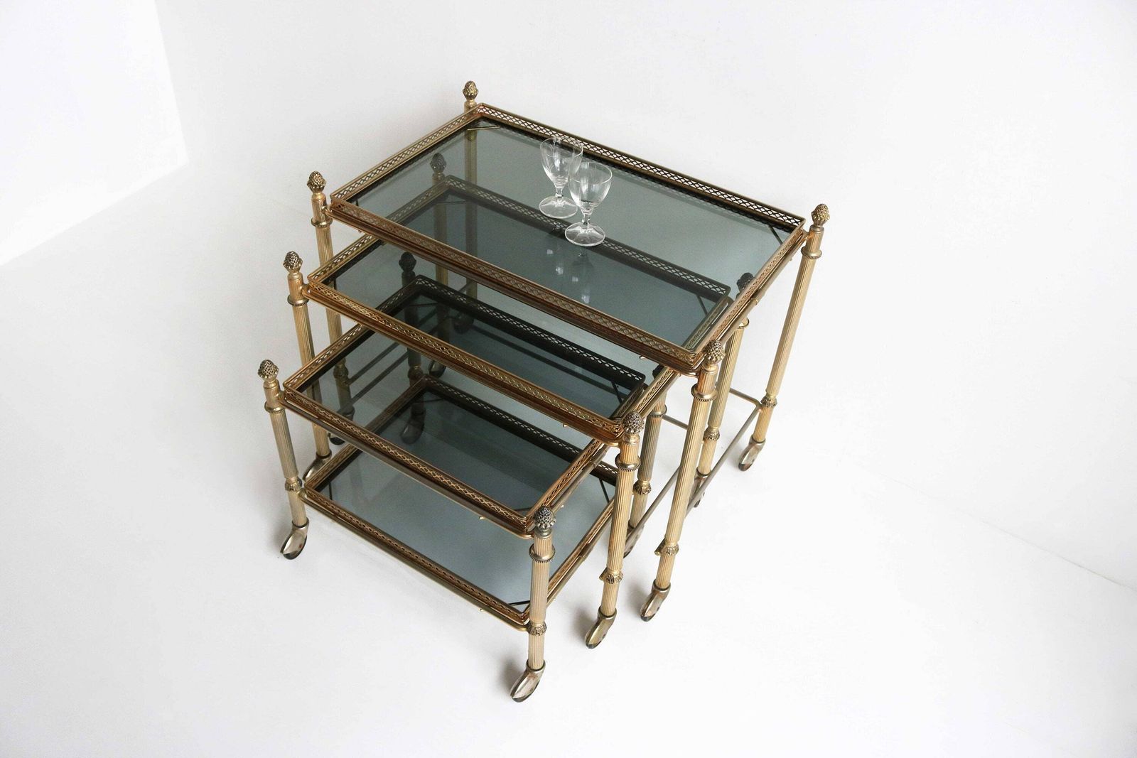 Neoclassical French Nesting Tables Maison Baguès Style Mid Century Smoked Glass Nesting Trolleys, Set Of 3 Vintage Side Tables 1960 photo for sale