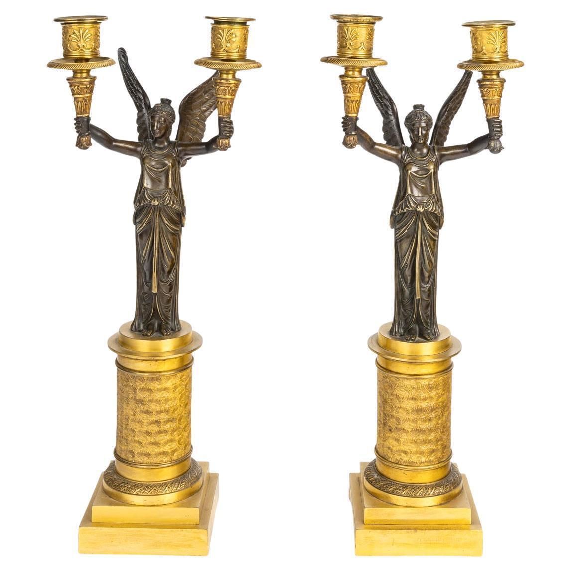A Pair Of Gilt Bronze And Patinated Candelabra With Winged Victories.