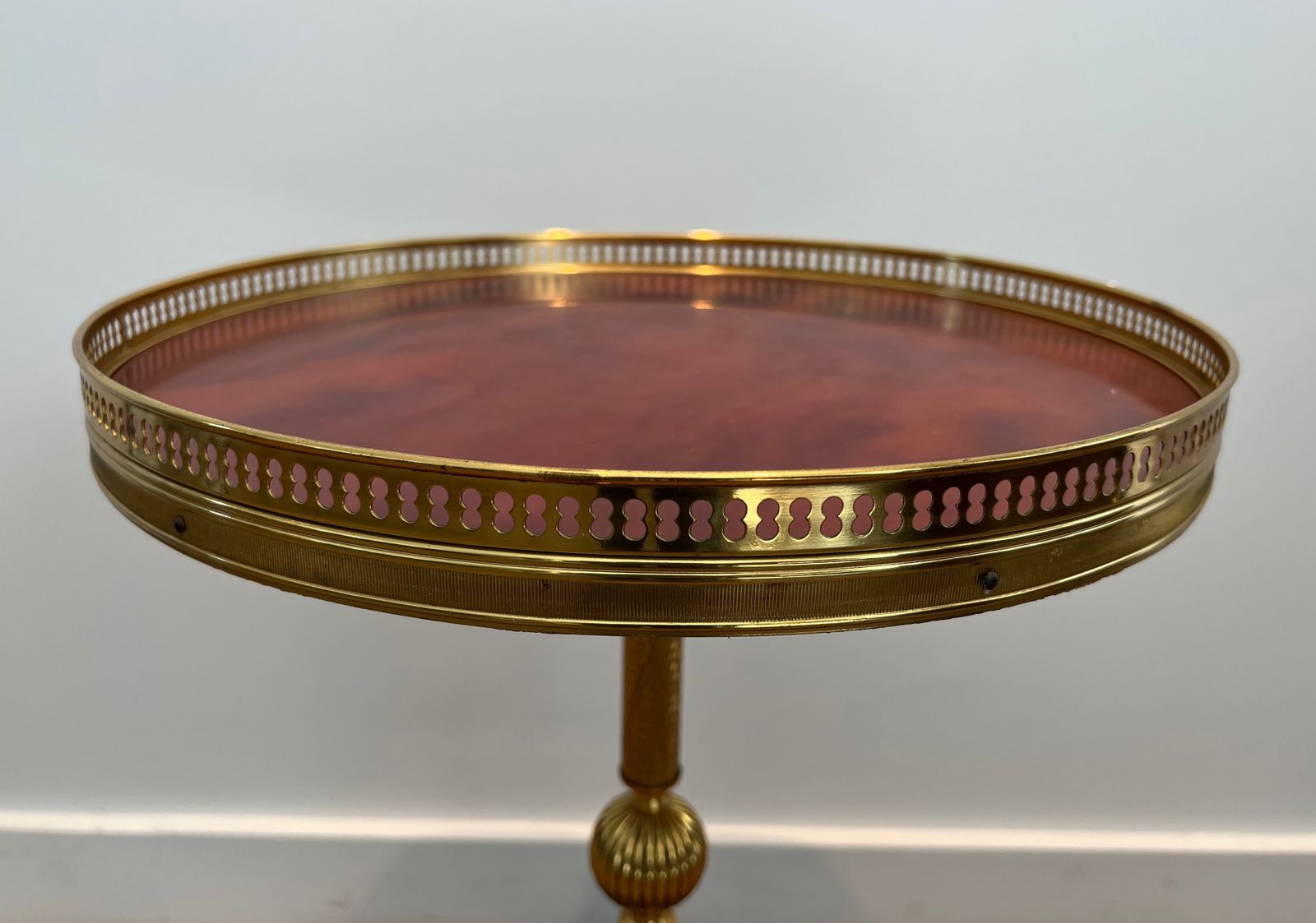 Round Neoclassical Style Brass Pedestal Table With Base Decorated With Dolphins And Red Celluloid Top Surrounded By An Openwork Gallery Attributed To photo buy