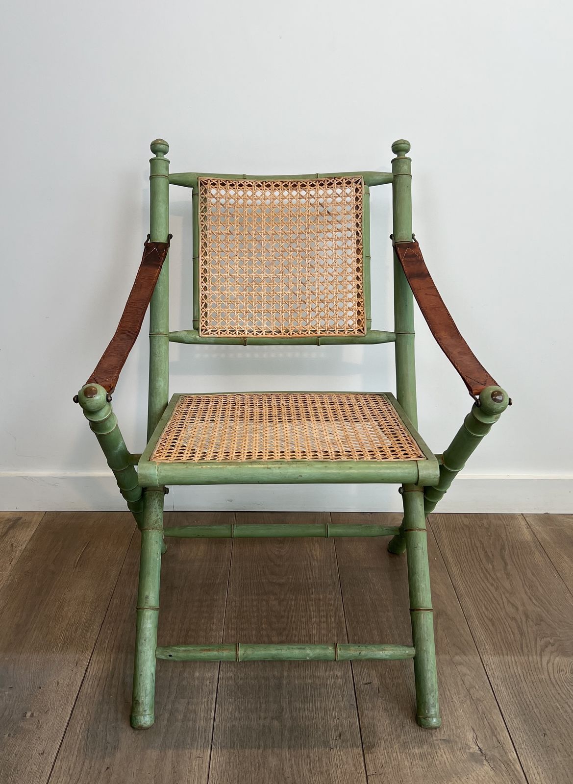 Pair Of Folding Safari Chairs In Weathered Faux Bamboo Style With Caned Backs And Seats And Leather Armrests photo vintage