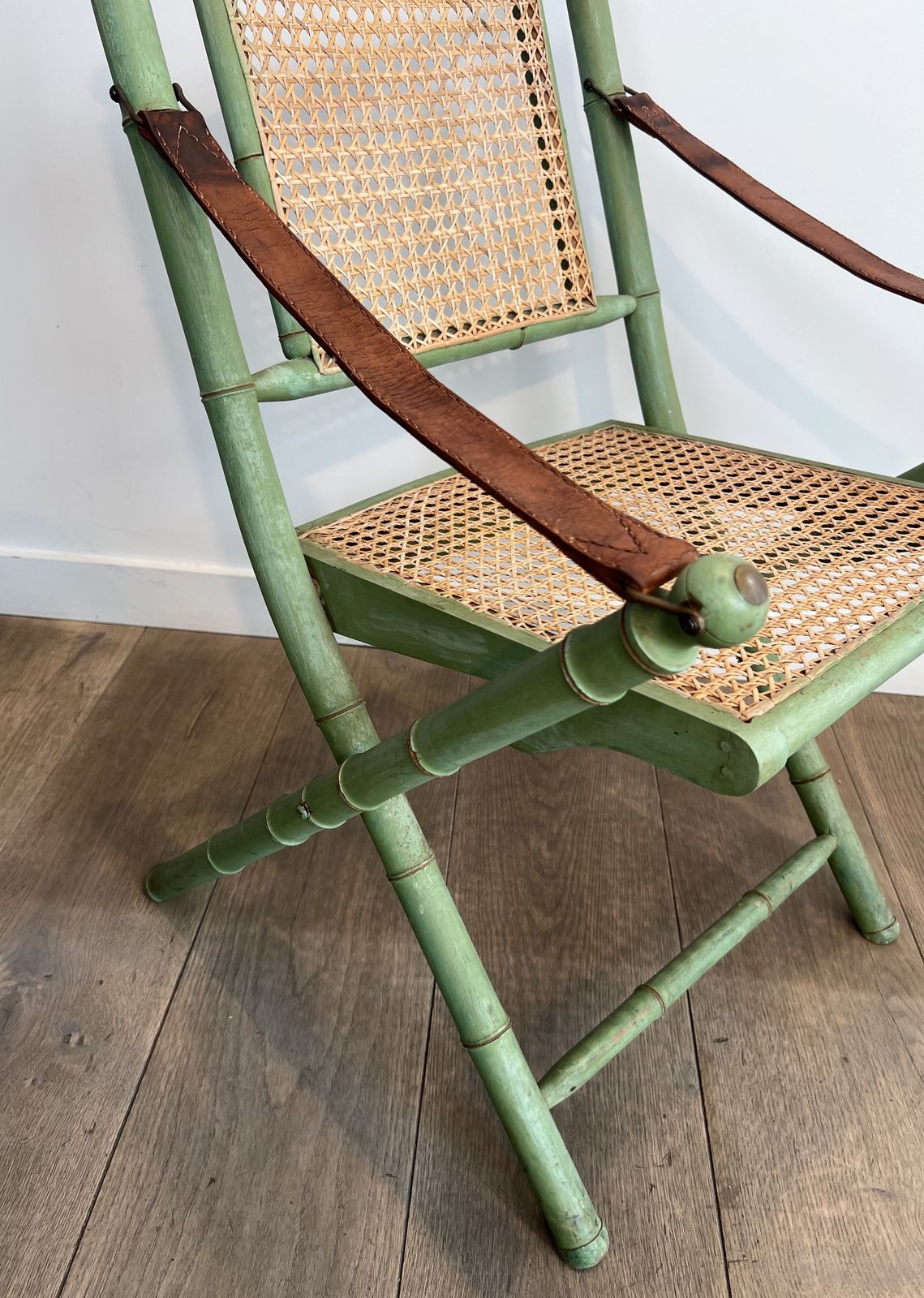 photo for sale Pair Of Folding Safari Chairs In Weathered Faux Bamboo Style With Caned Backs And Seats And Leather Armrests