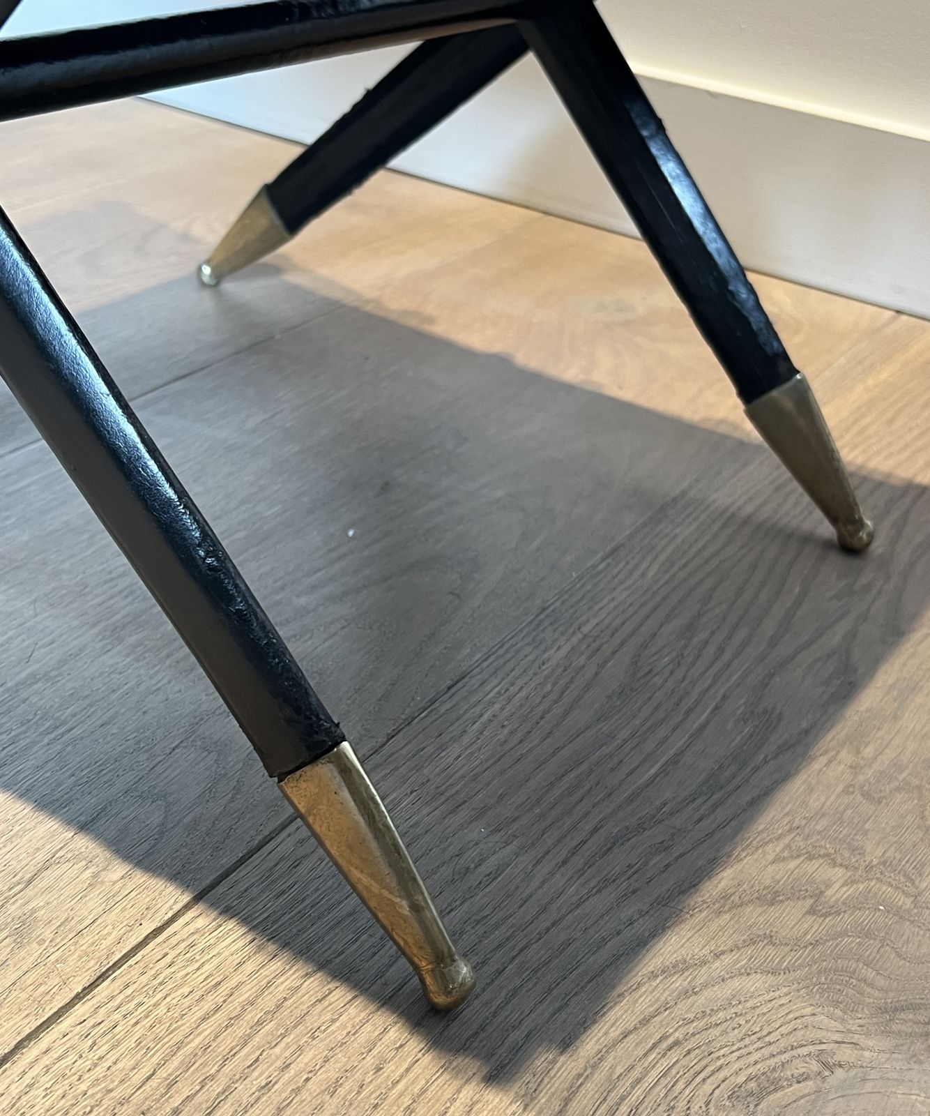 photo for sale Neoclassical Style Curule Stool In Red Leather And Decorated With Crossed Swords In Bronze And Metal Covered In Black Leather