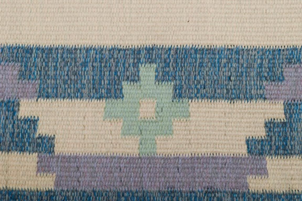 Swedish Carpet In Pure Wool. Geometric Pattern In Blue, White, And Pink Colors. photo vinterior