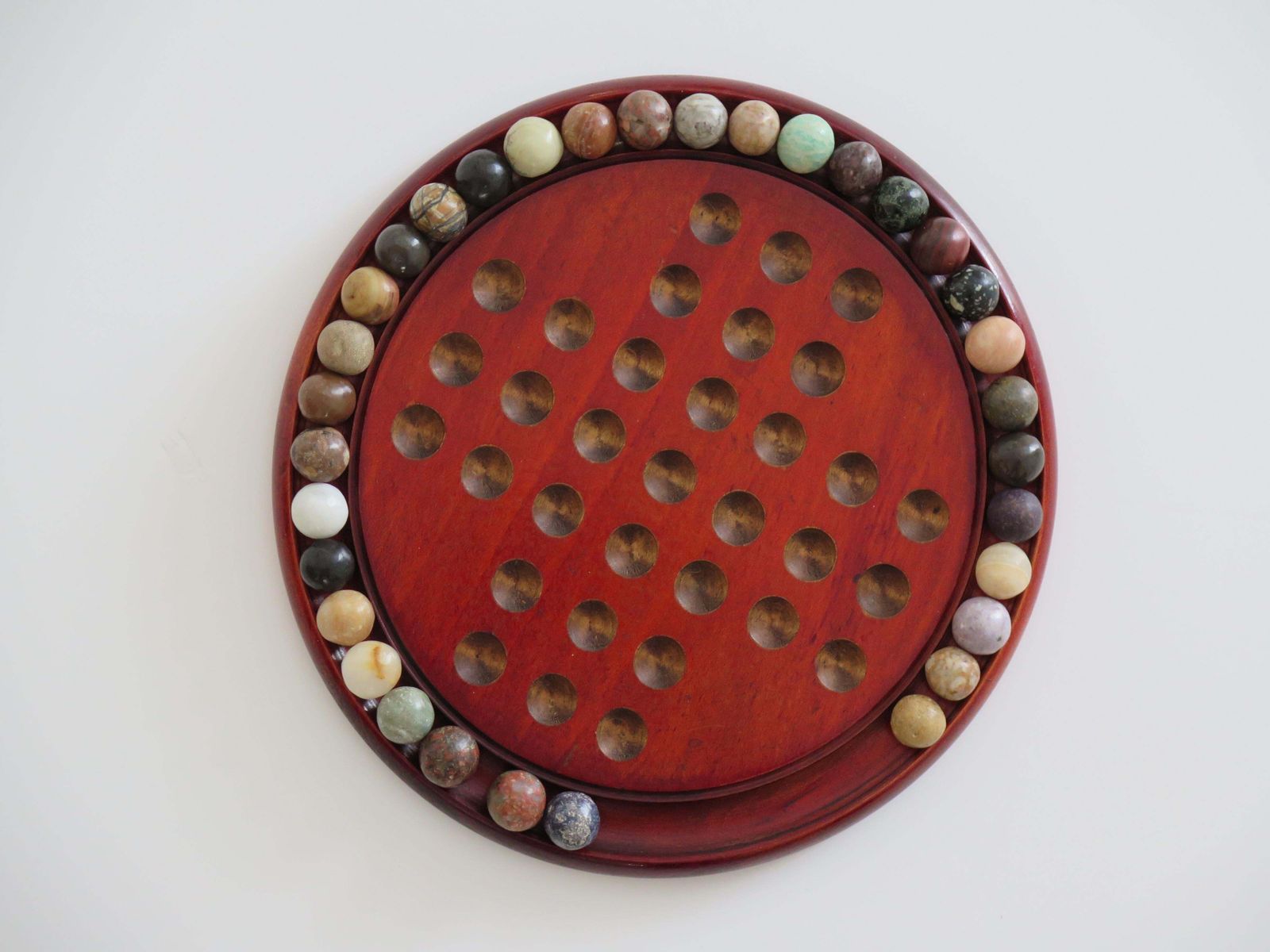 photo buy Marble Solitaire Game With Hardwood Board And 33 Agate Stone Marbles, Circa 1925
