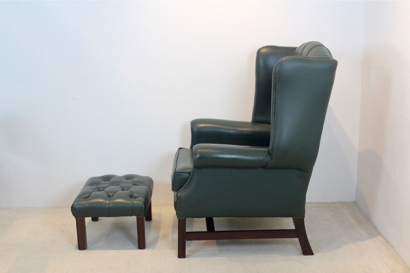Classic Chesterfield Wingback Armchair With Footstool In Green Leather photo furniture