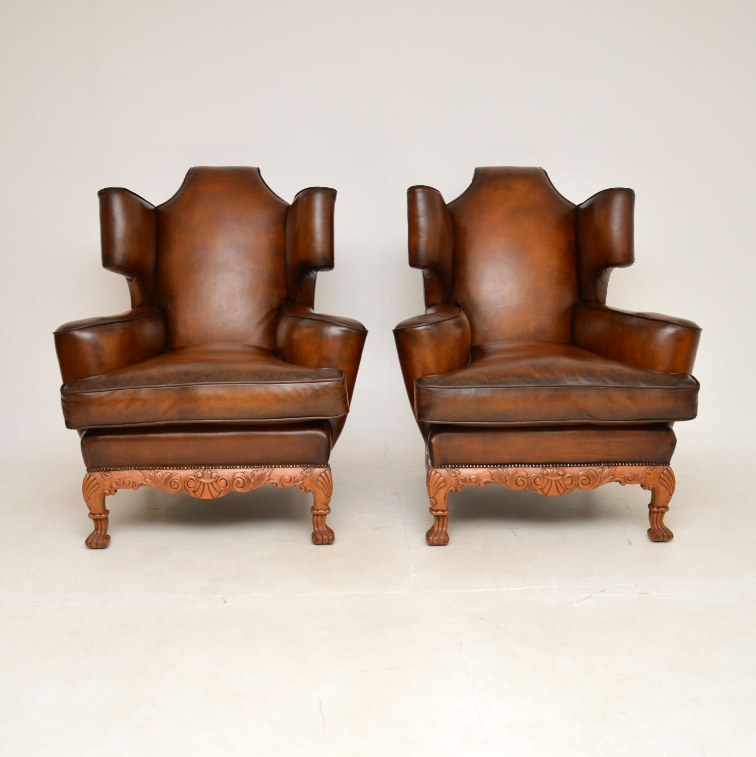 Pair Of Antique Leather Wing Back Armchairs photo for sale