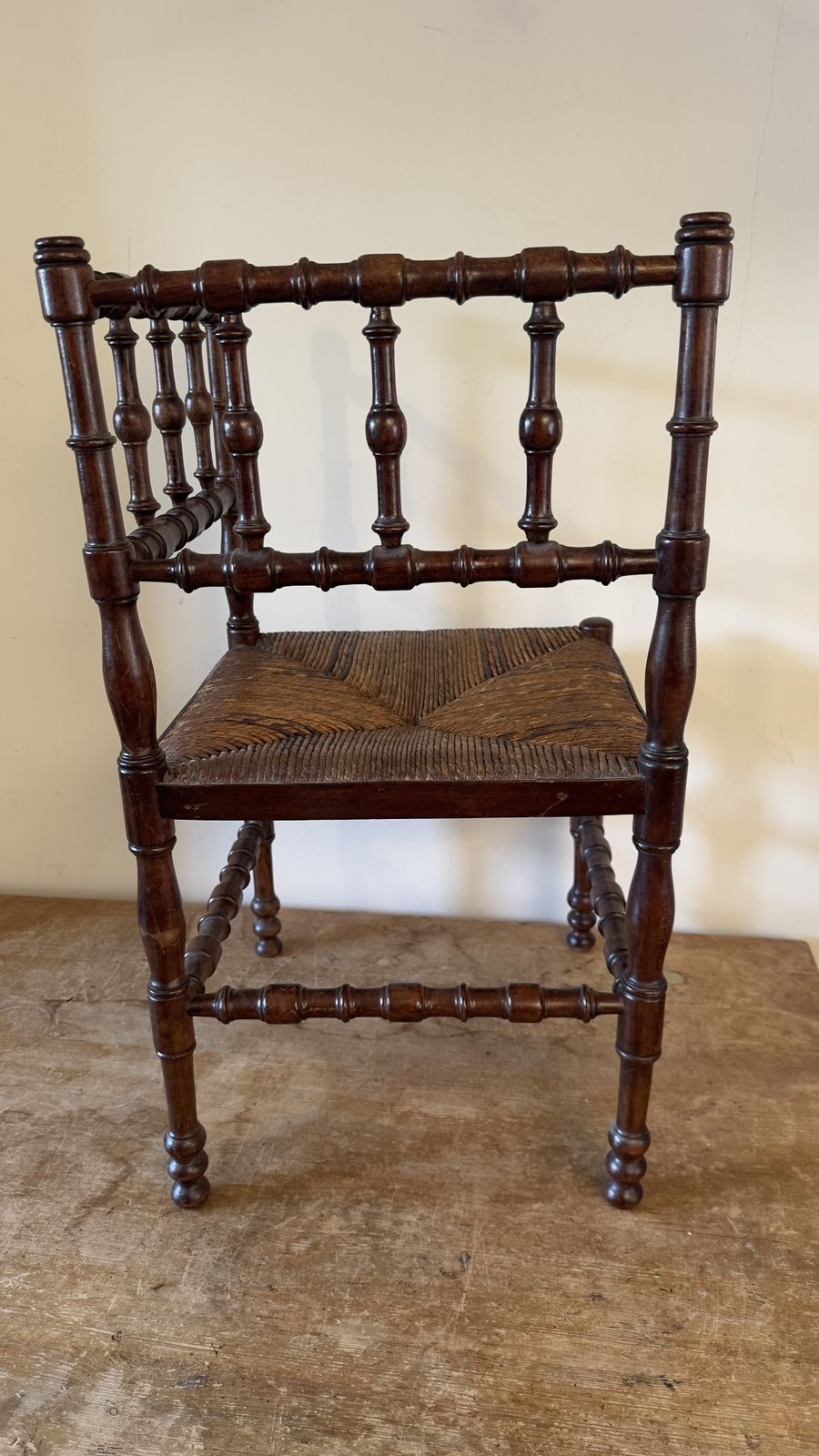 Vintage French Bobbin Corner Chair With A Woven Raffia Seat. photo vinterior