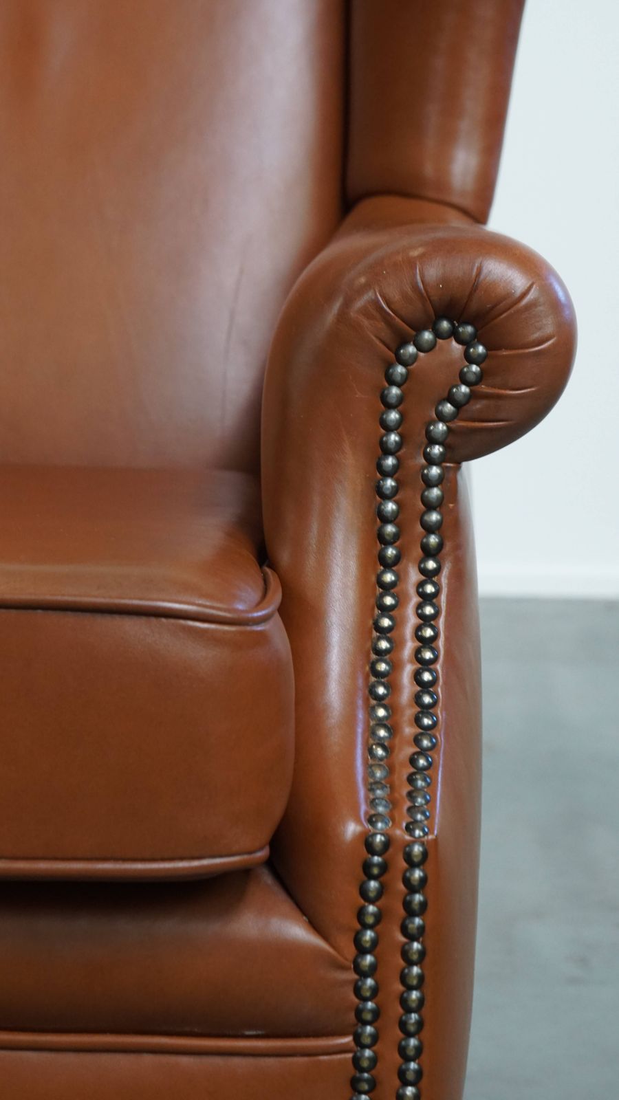 photo for sale Stylish And In Good Condition Cognac Colored Cowhide Armchair In English Style With Decorative Nails