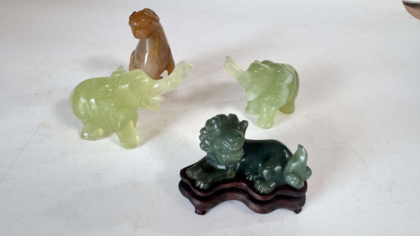photo for sale Set Of 4 Chinese Animal Figurines In Jade And Onyx – Elephants, Lion & Dog, 20th