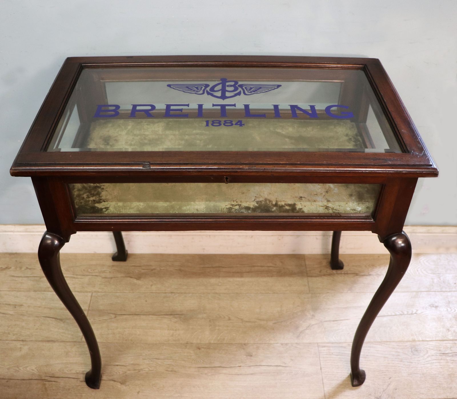 A Wonderful Vintage Bijouterie Display Table And Sign Written Detail For Breitling Watches.