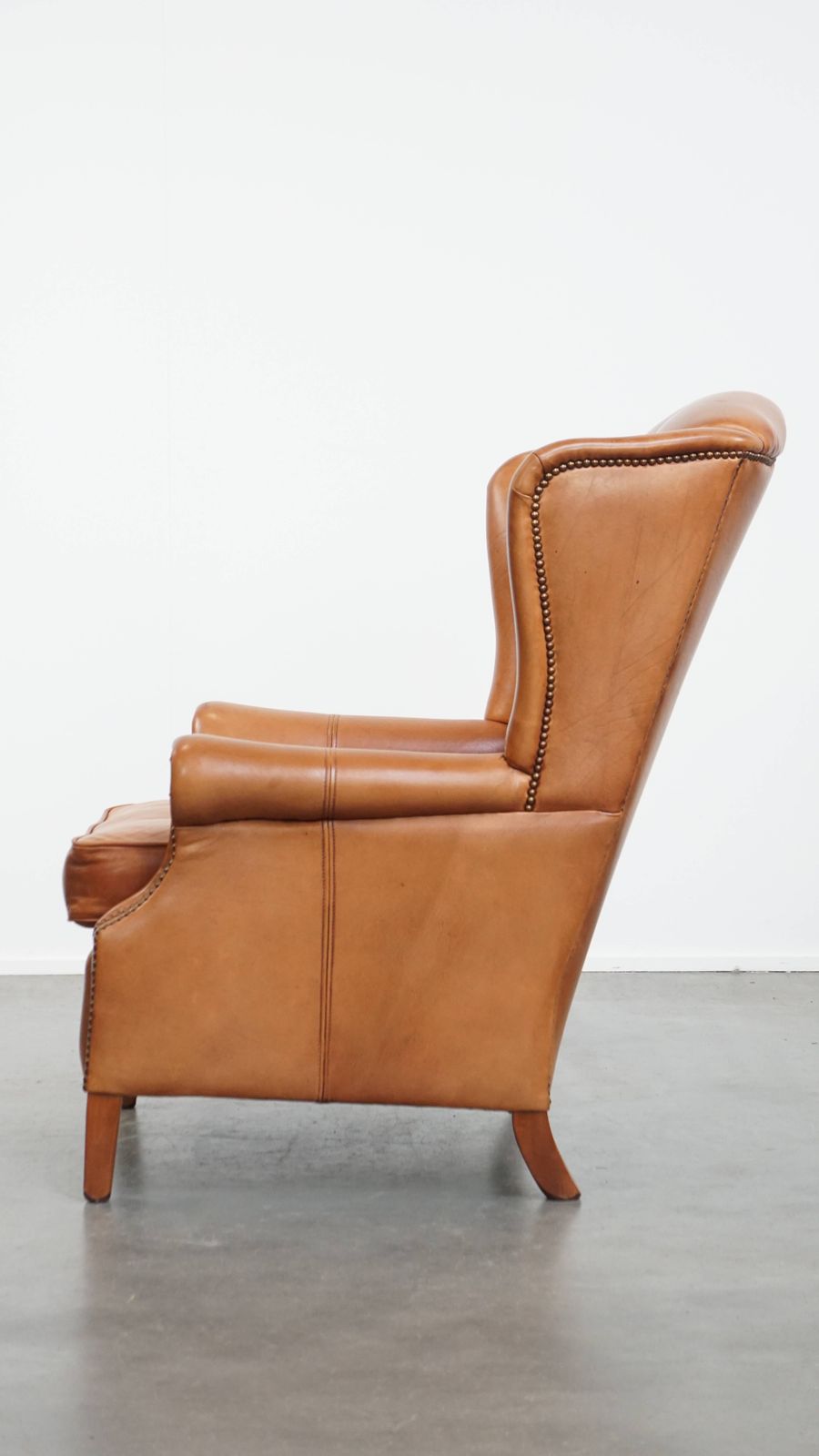 Classic And Unique Cowhide Wing Chair Finished With Decorative Nails And Beautiful Details photo 878.0