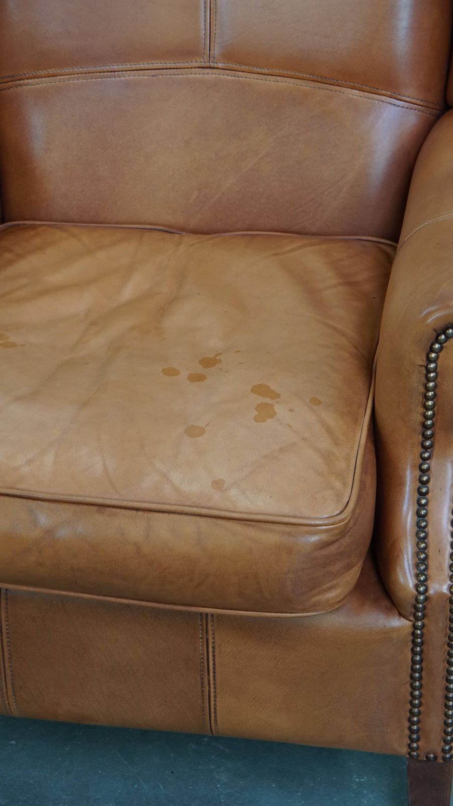 Furniture Classic And Unique Cowhide Wing Chair Finished With Decorative Nails And Beautiful Details photo