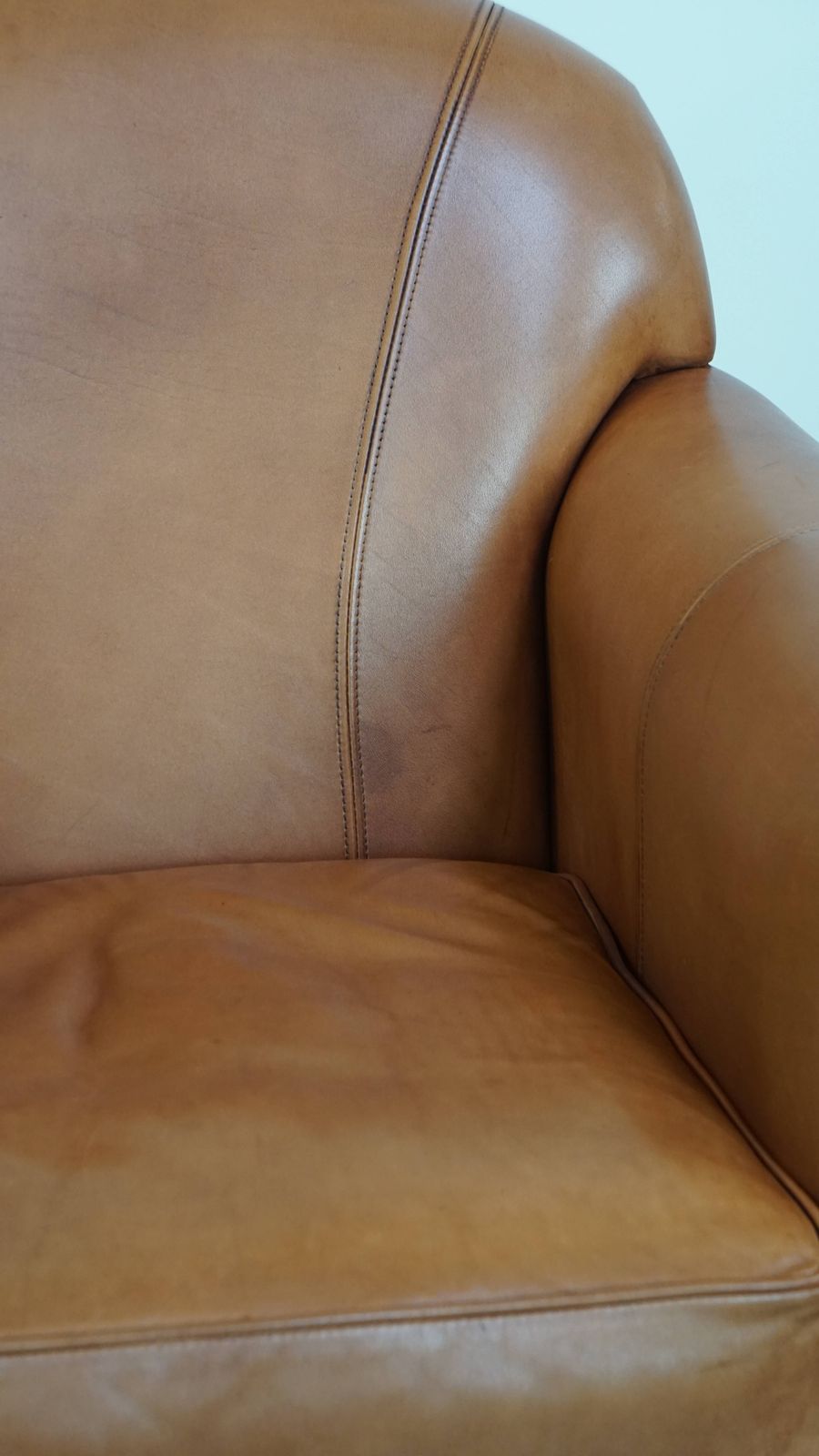 photo for sale Beautiful And Comfortable Cowhide Leather Armchair In A Warm Cognac Color Finished With Decorative Nails