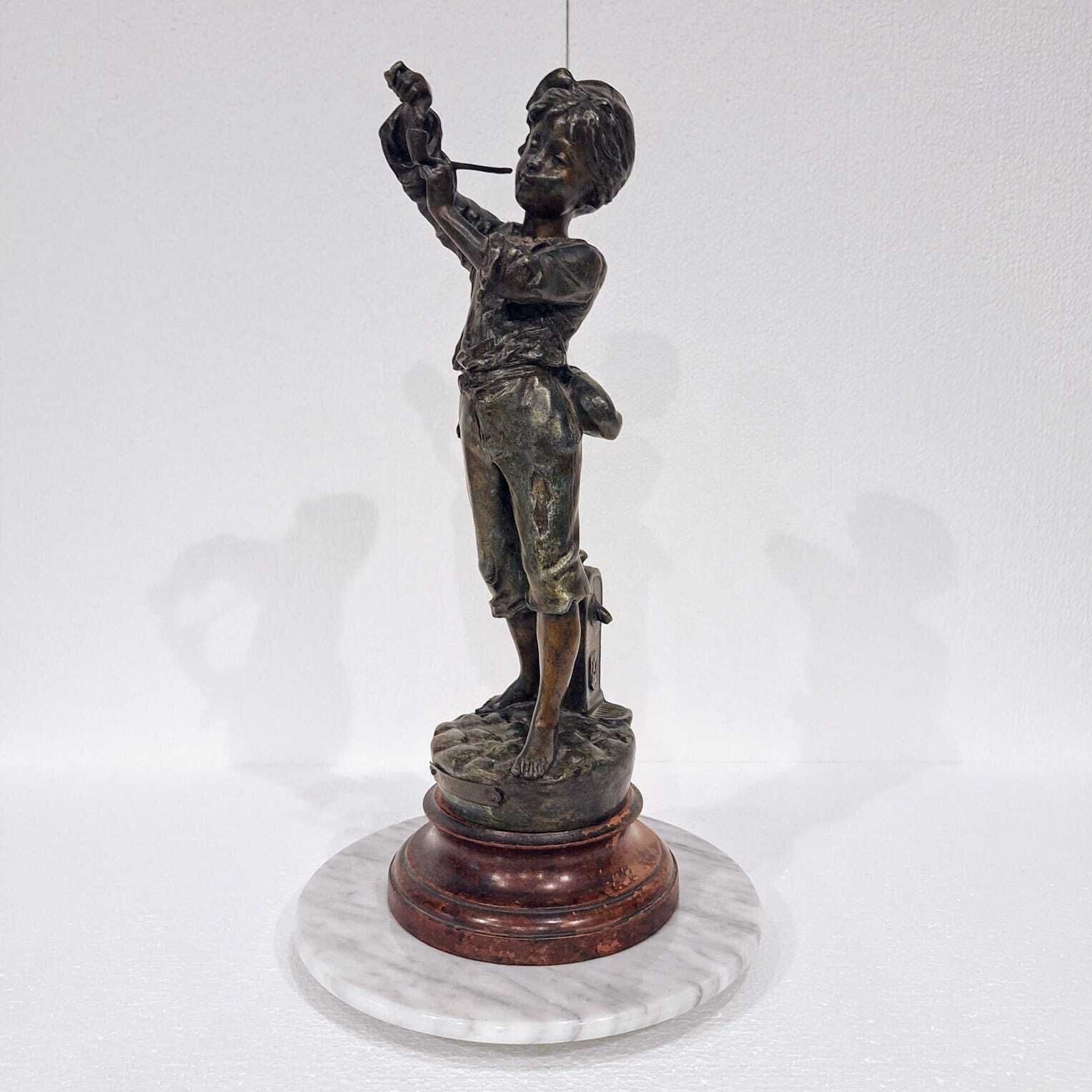 A French Spelter Statue Of A Boy Lighting A Pipe photo furniture