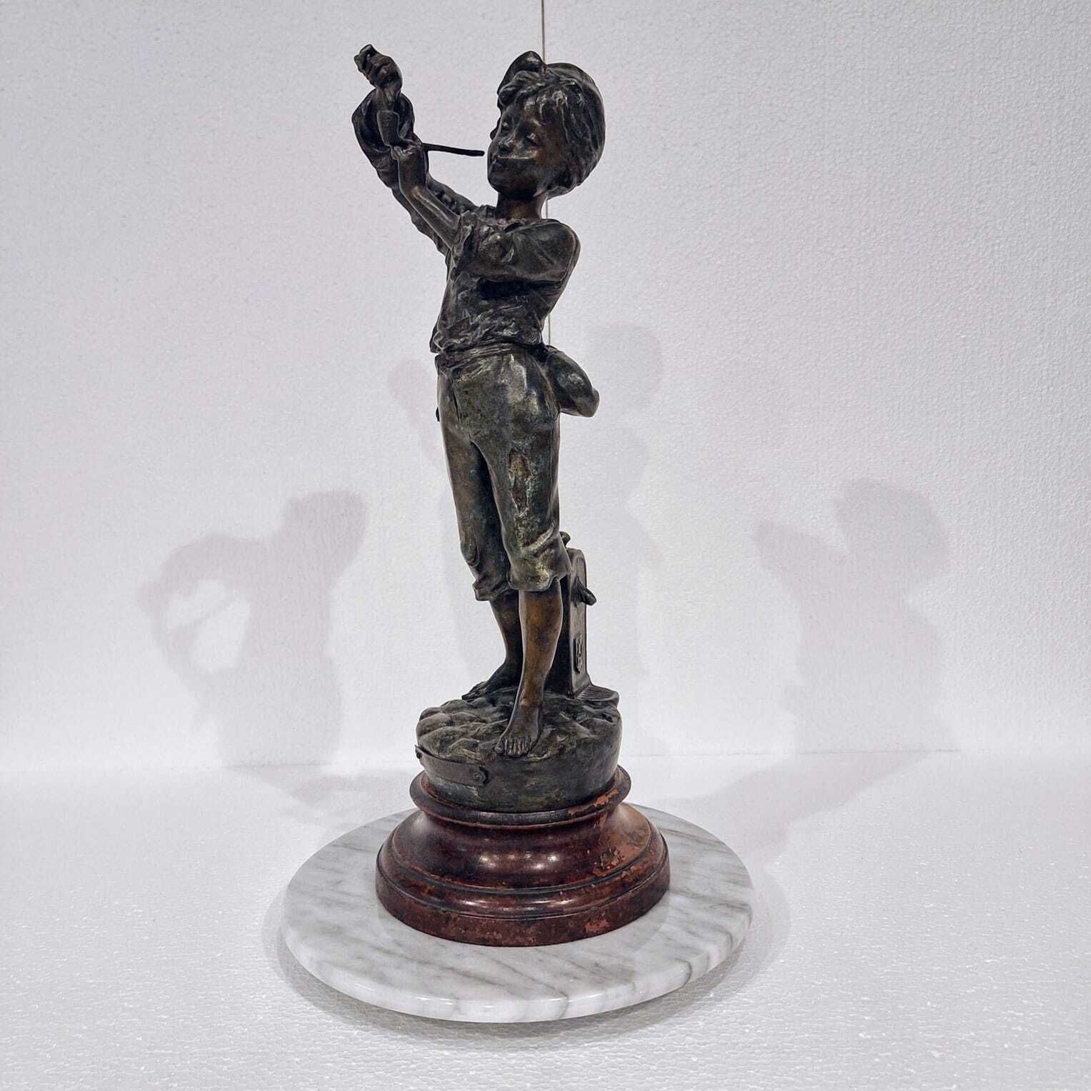A French Spelter Statue Of A Boy Lighting A Pipe photo vinterior