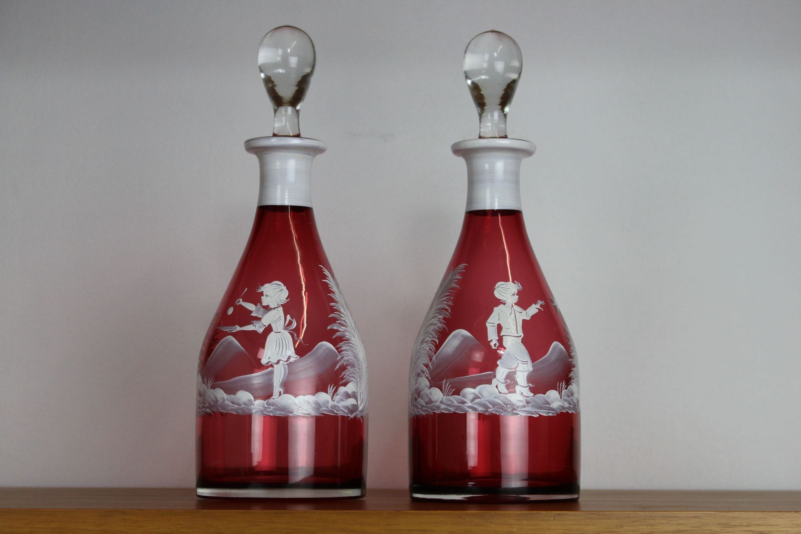 Pair Of Mary Gregory Style Cranberry Glass Decanters
