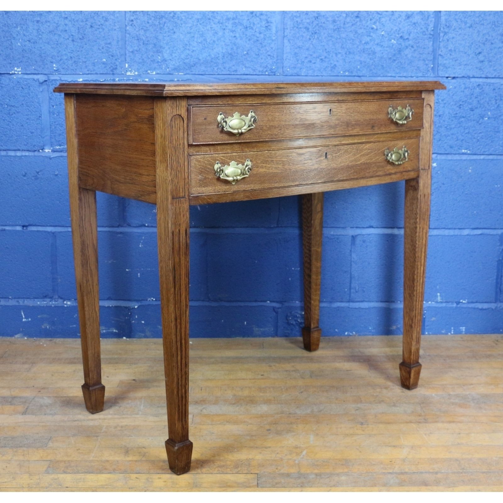 A Quality Oak Bow Fronted Two Drawer Side Table Raised On Tapering Spade Feet photo for sale
