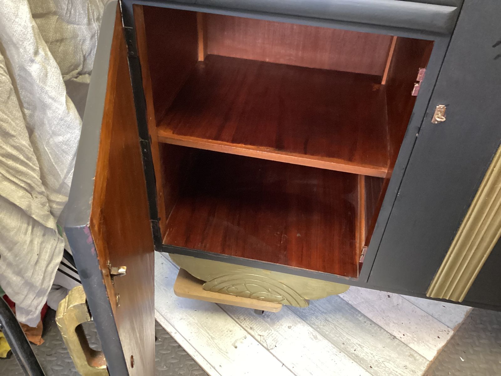 Art Deco Black And Gold Dresser With Gold  Detailing Interior Shelving And Bottle Storage photo 350.0