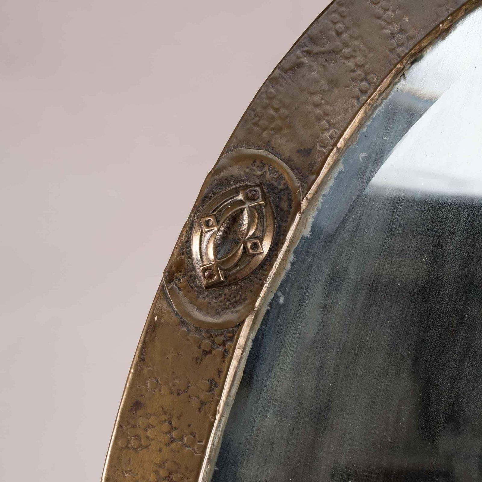 An Arts And Crafts Brass Hand Hammered Mirror With Four Celtic Style Details photo for sale