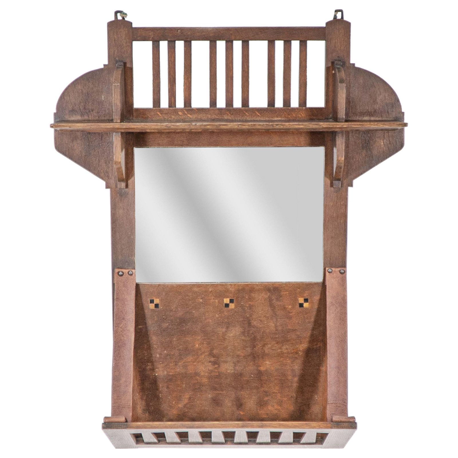 Liberty And Co. An Arts & Crafts Oak Hanging Paper Rack With Central Mirror