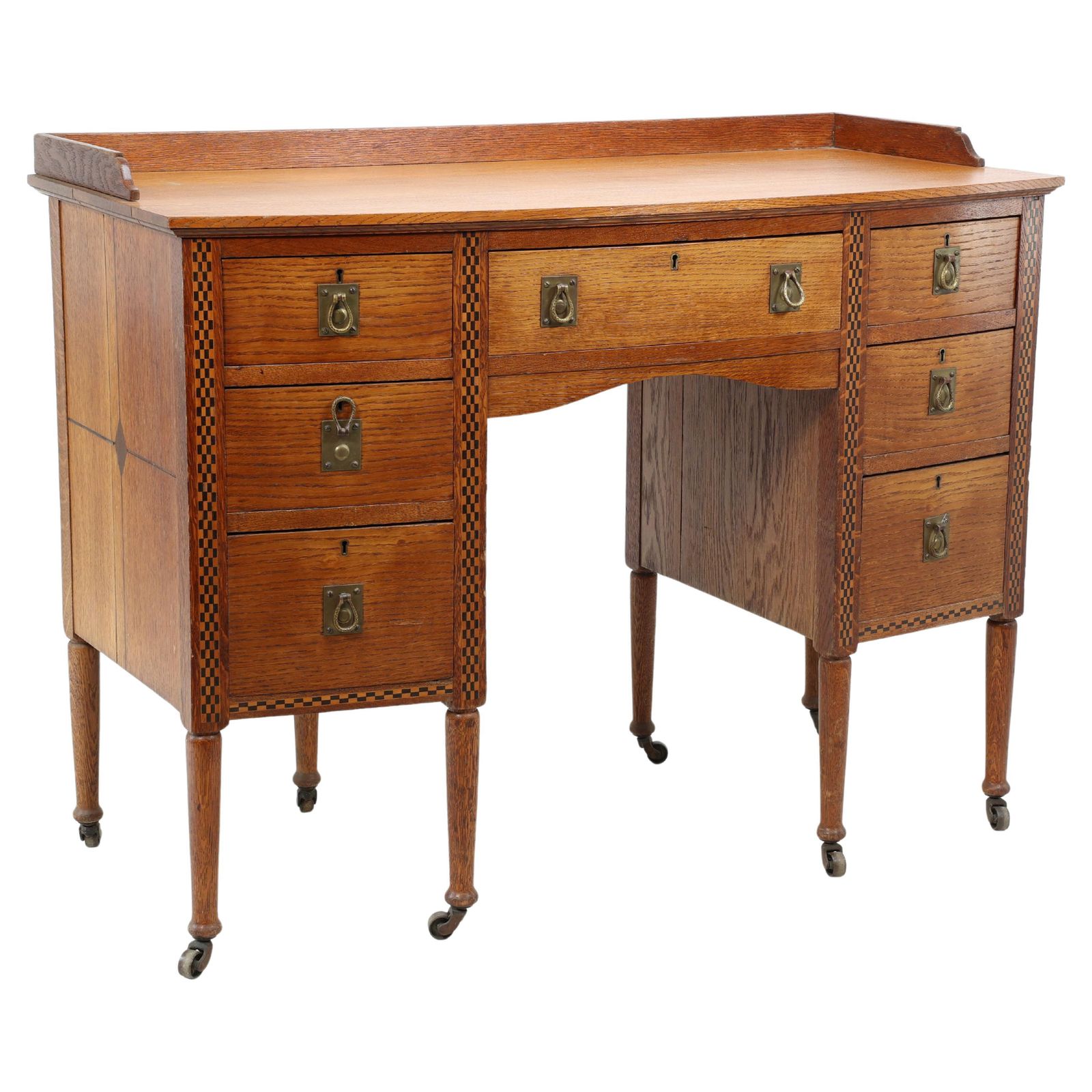 Waring And Gillow. An Arts And Crafts Bow Fronted Kneehole Twin Pedestal Desk