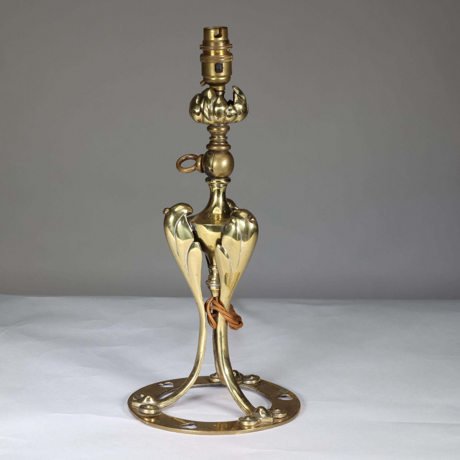 An Arts & Crafts Brass Table Lamp Tulip Shaped With Heart Cut Outs To The Base photo for sale