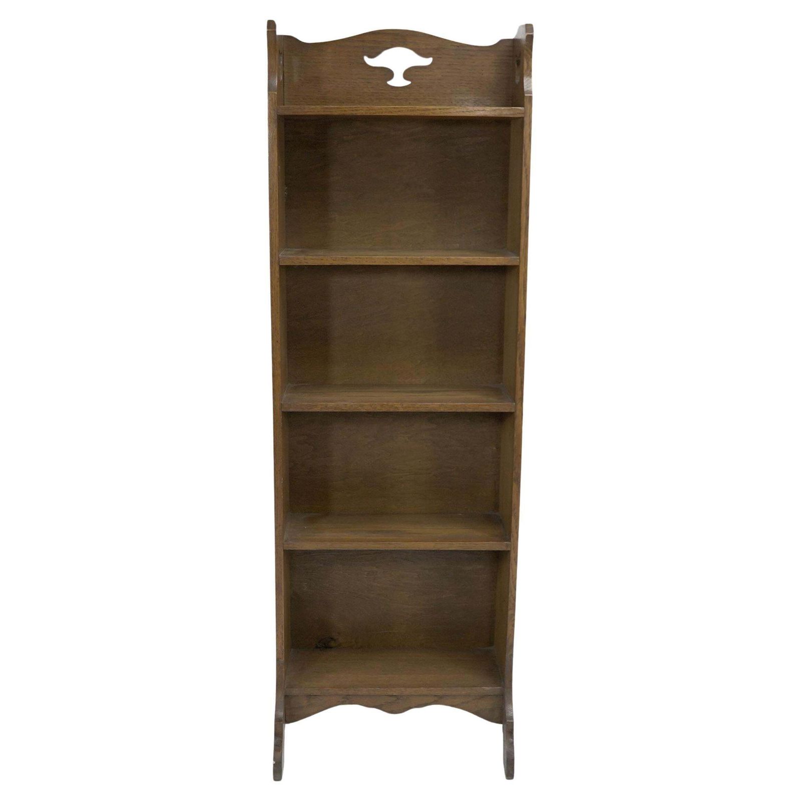Liberty & Co. A Slim Arts And Crafts Oak Bookcase With Stylized Floral Cut Outs