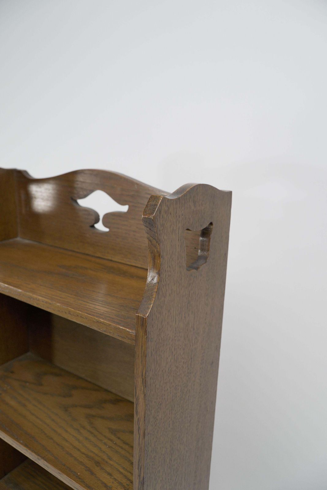 Liberty & Co. A Slim Arts And Crafts Oak Bookcase With Stylized Floral Cut Outs photo Furniture