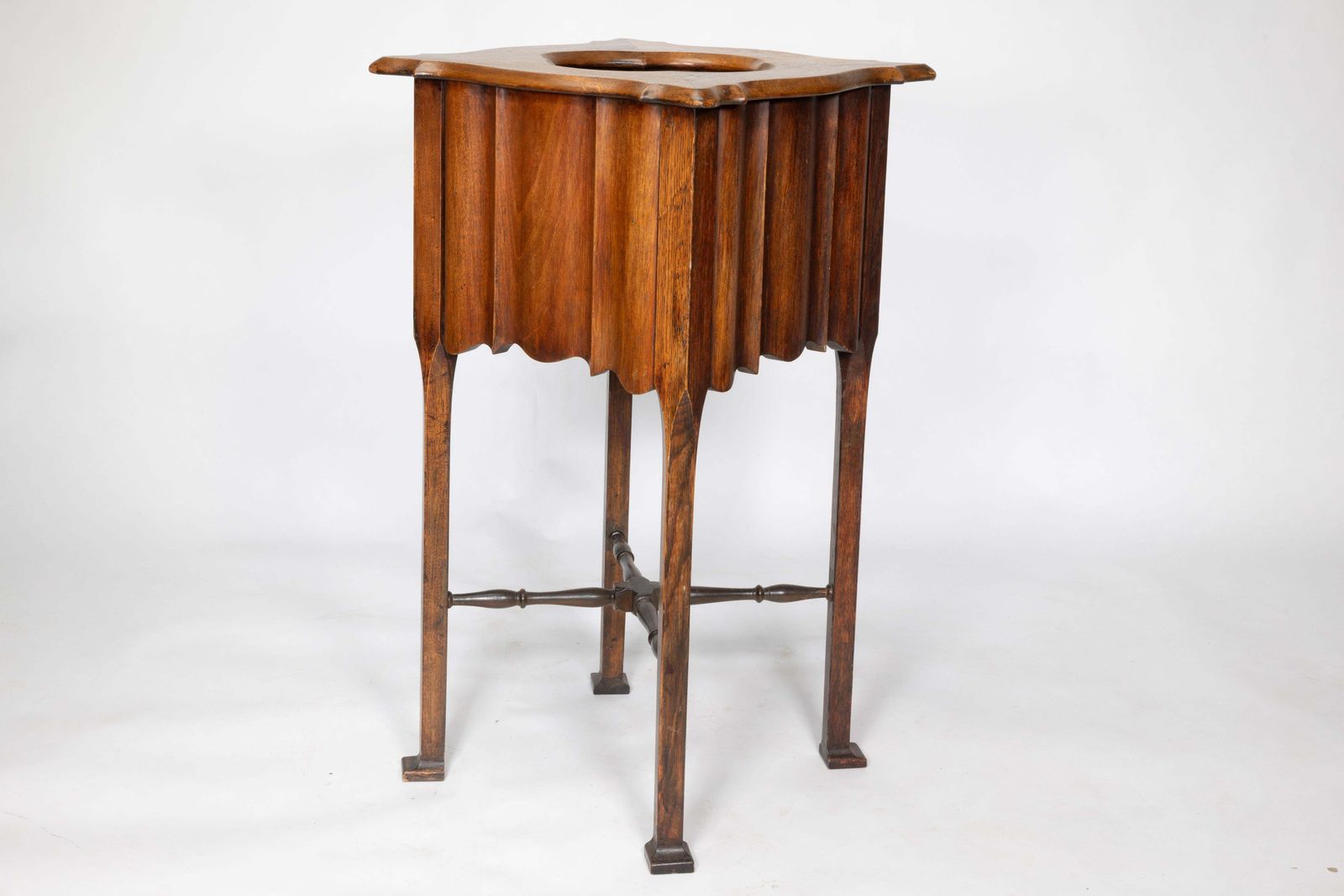 An Arts And Crafts Walnut Plant Stand With A Shaped Top And Ribbed Style Sides photo for sale