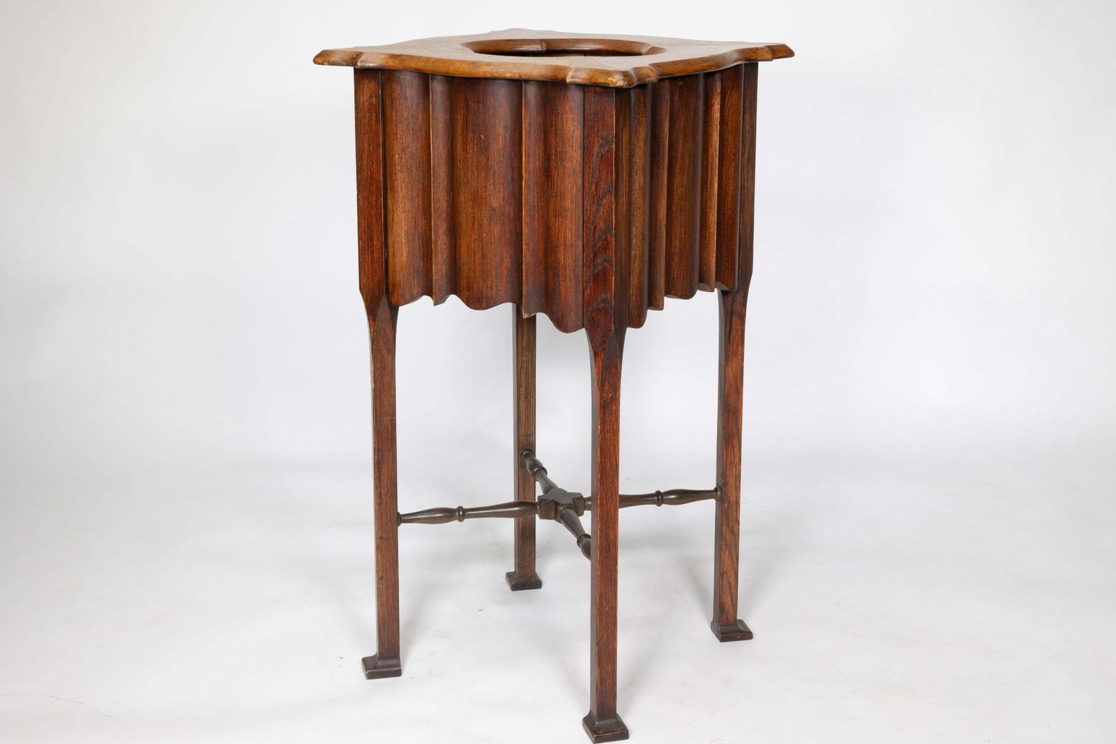 An Arts And Crafts Walnut Plant Stand With A Shaped Top And Ribbed Style Sides photo 1428.0