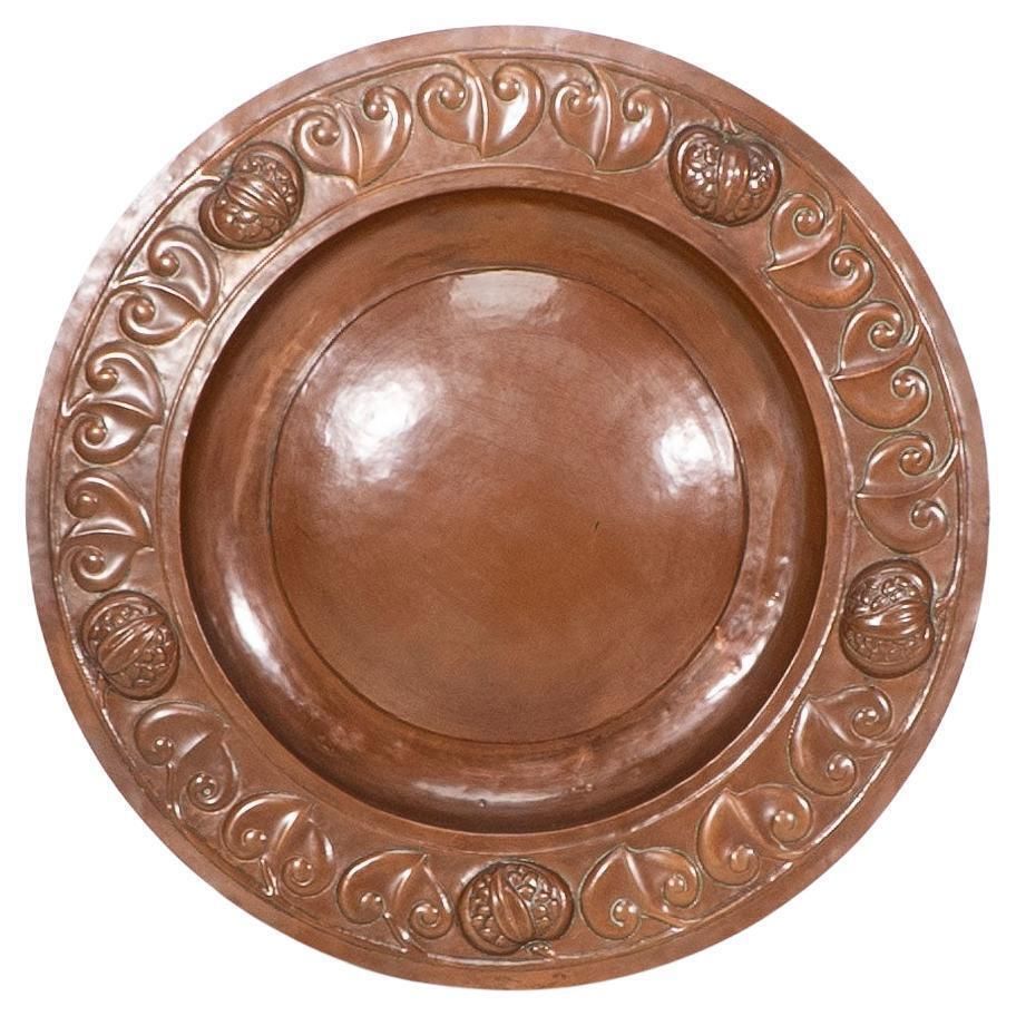 A Large Arts And Crafts Hand Formed Copper Charger With Stylized Decoration