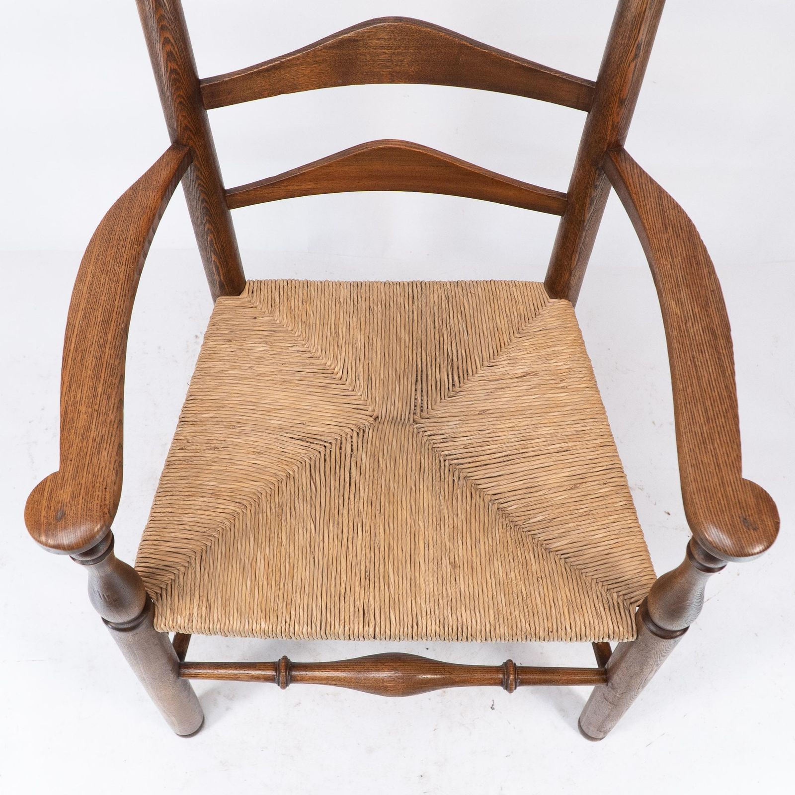 photo furniture C R Ashbee Attr. An Arts & Crafts Oak Ladder Back Armchair With Re Rushed Seat