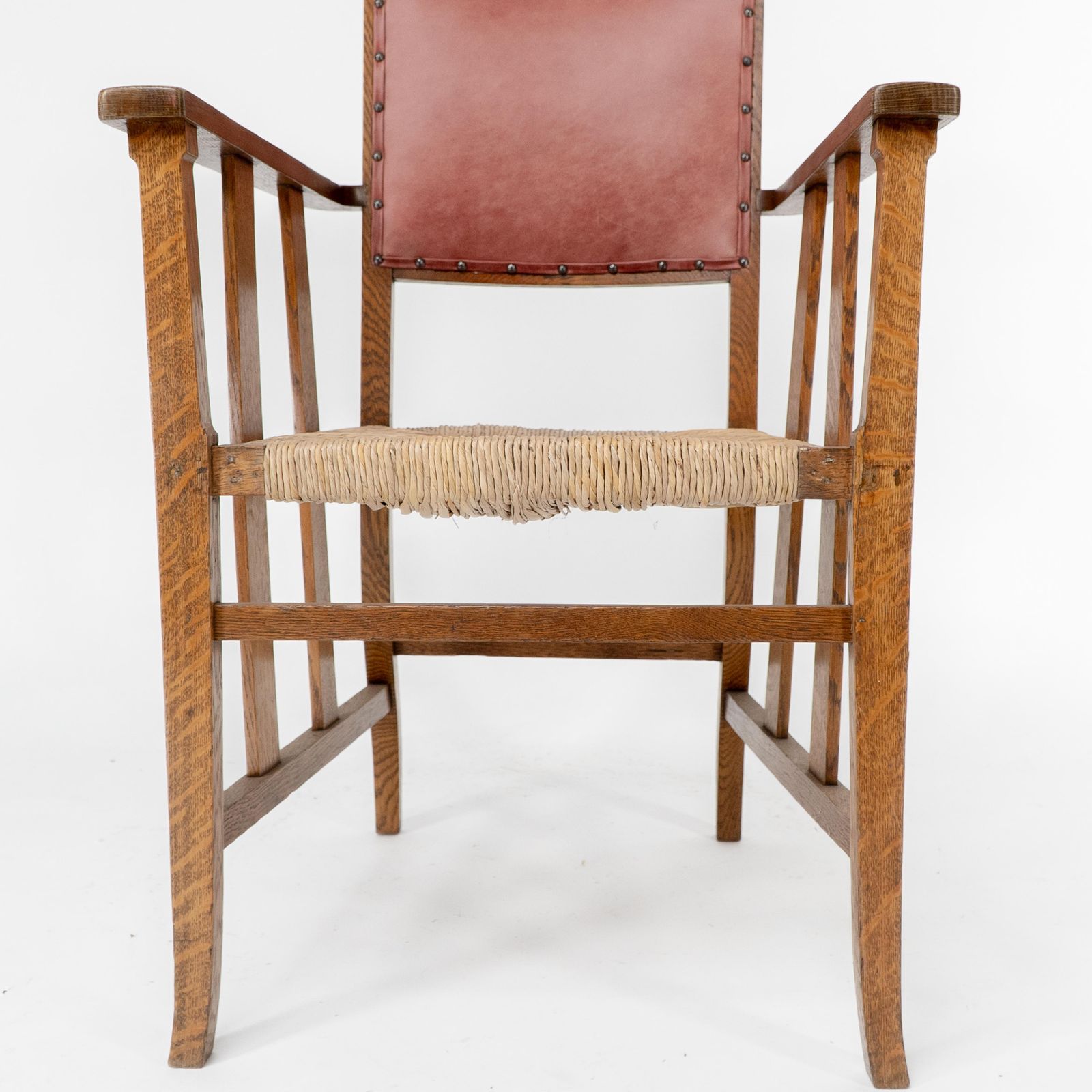 1836.0 Liberty & Co. An Arts & Crafts Rush Seat Armchair With A Shaped Back photo