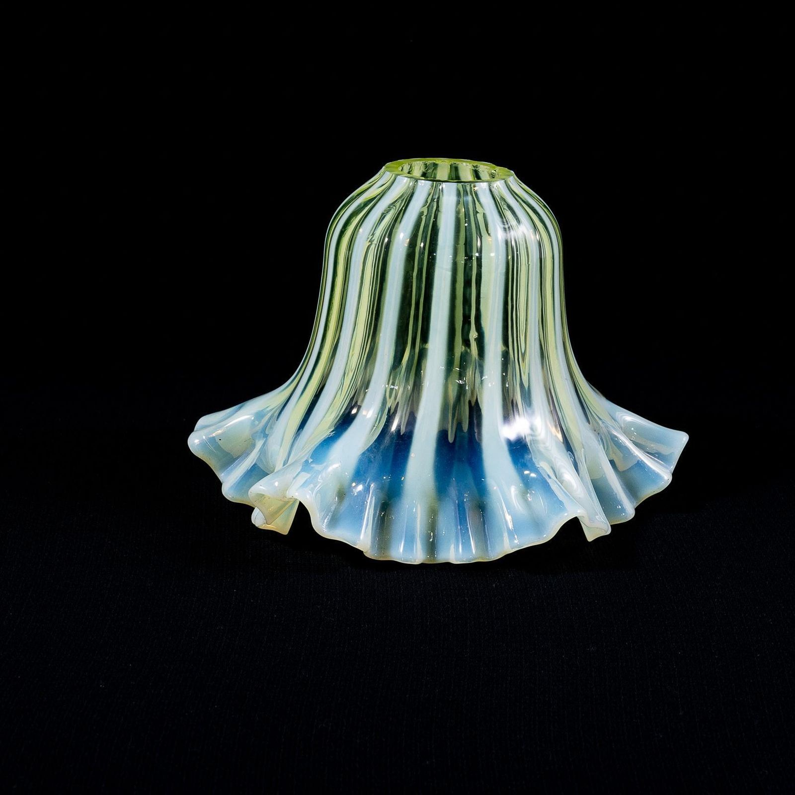 Lighting A Pleated Vaseline Shade, Consisting Of Alternating Stripes And A Ruffled Rim. photo