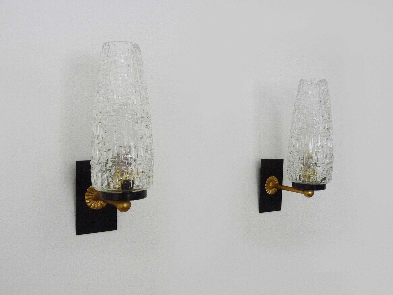 Superb Pair Of Brass Wall Sconces With Glass Globes. The Black Wall Part Is Made Of Metal.