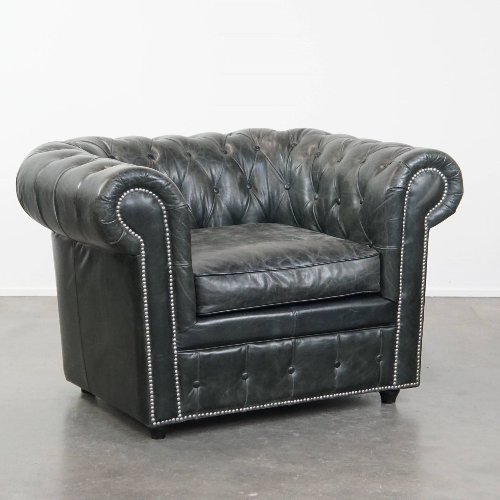 Timeless And Classic Spacious Black Chesterfield Armchair Made Of Characterful Grained Cowhide