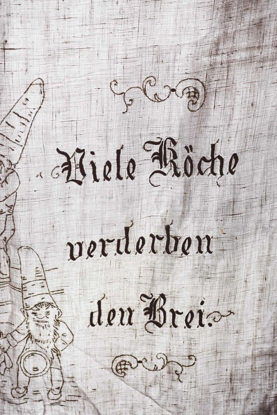 Vintage German Linen Tea Towel | Hand Embroidered Gnomes Kitchen Scene | "Viele Köche Verderben Den Brei" | 60.5x110cm photo furniture