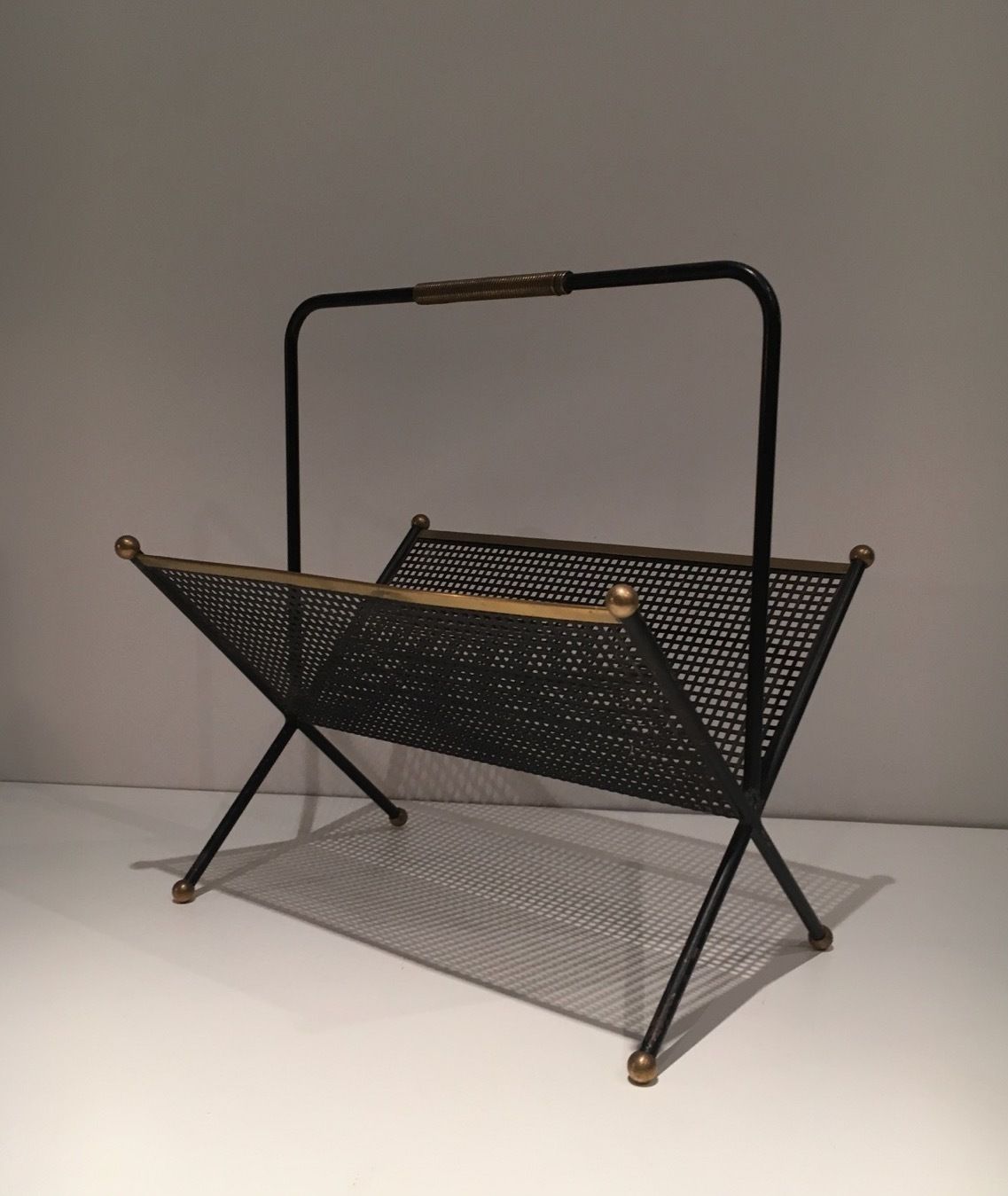 photo furniture Design Magazine Rack In Black Lacquered Metal, Perforated Sheet Metal And Brass