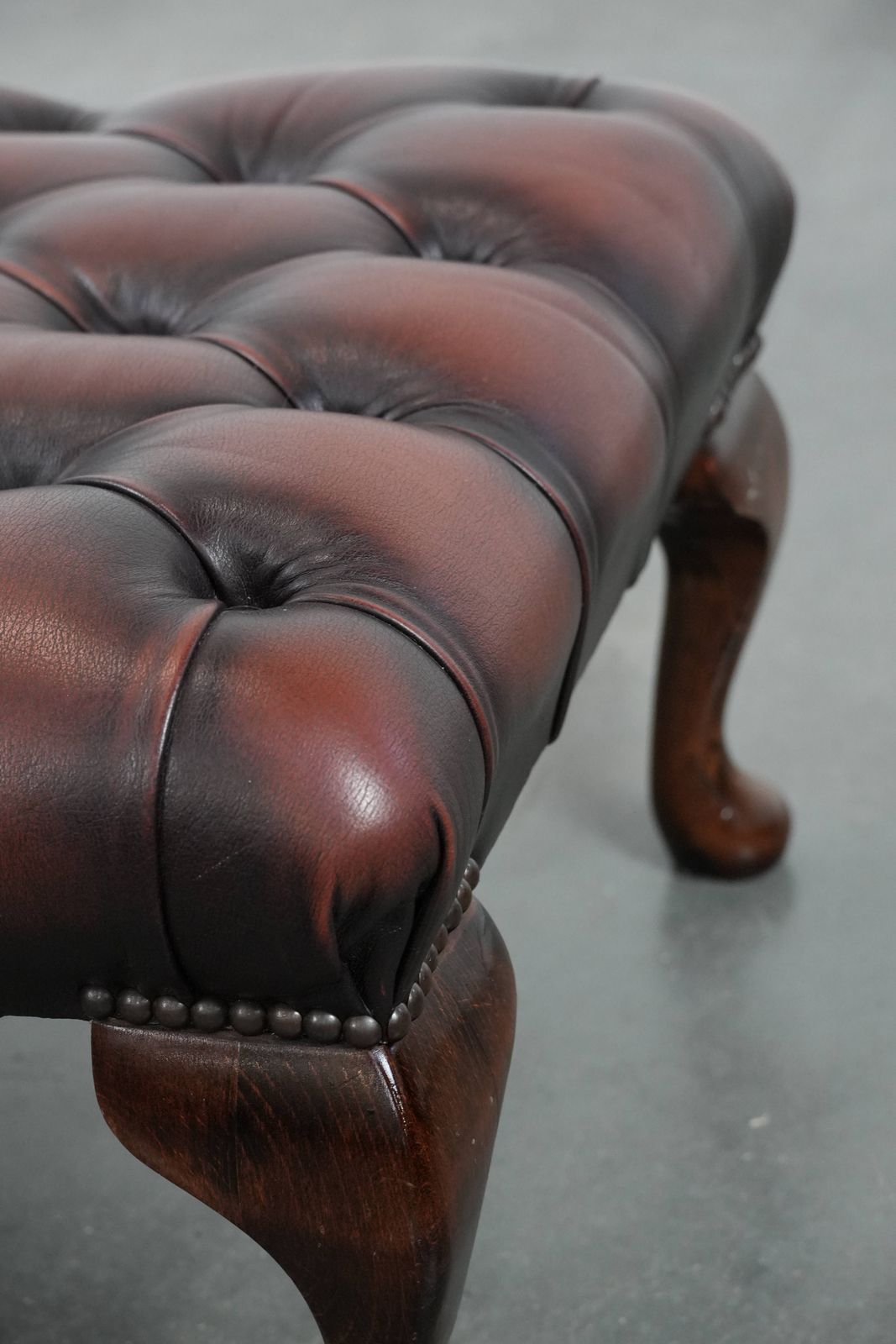 Furniture Elegant And Graceful Dark Brown Chesterfield Footstool Made Of Cowhide photo