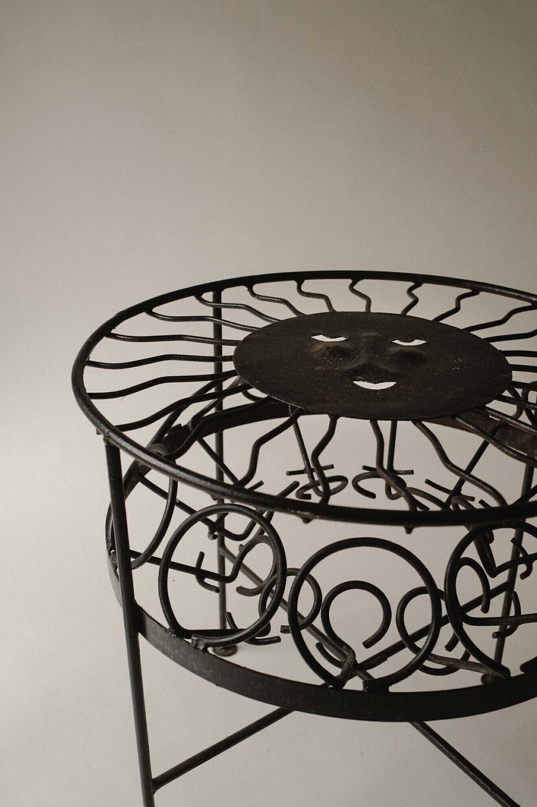photo furniture Sculptural Iron Table With Sunburst Face