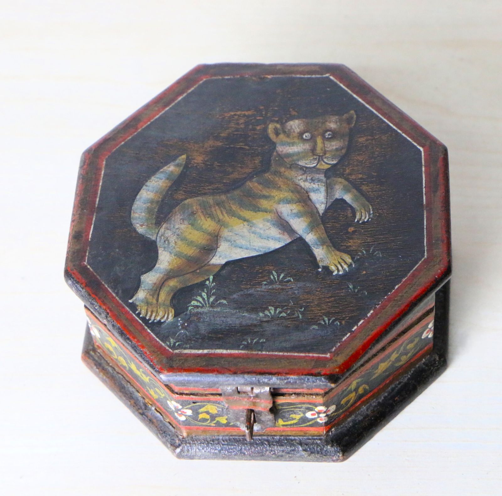 An Antique Indian Hand Painted Octagonal Trinket Box With A Stylised Tiger Design photo furniture