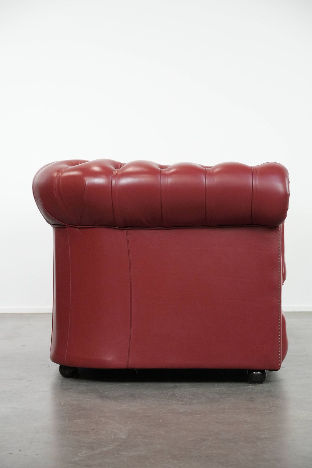 Wonderful Set Consisting Of An English Cowhide Chesterfield 2.5 Seater Sofa And Matching Armchair In A Stunning Red Colour photo for sale