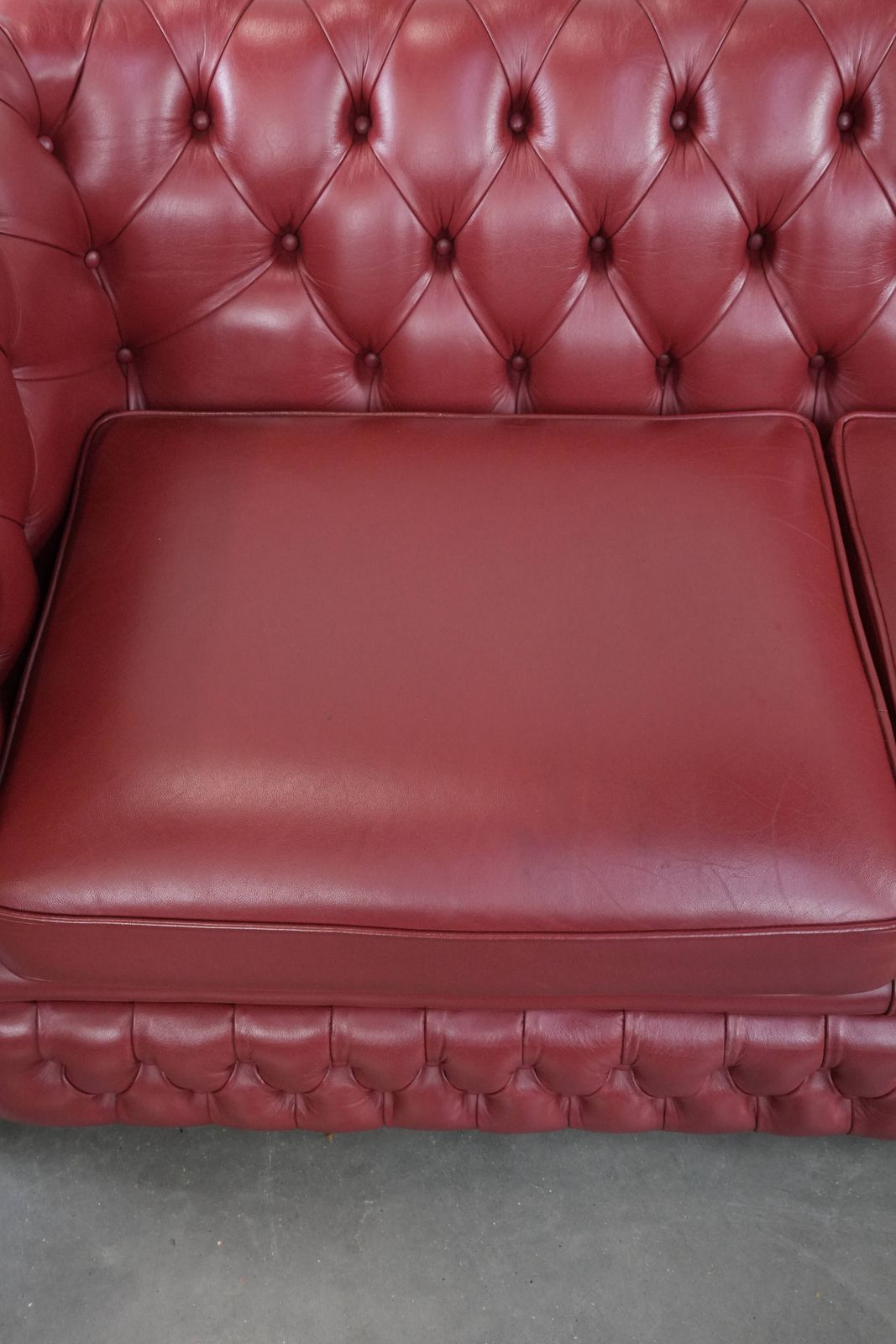 Wonderful Set Consisting Of An English Cowhide Chesterfield 2.5 Seater Sofa And Matching Armchair In A Stunning Red Colour photo vinterior