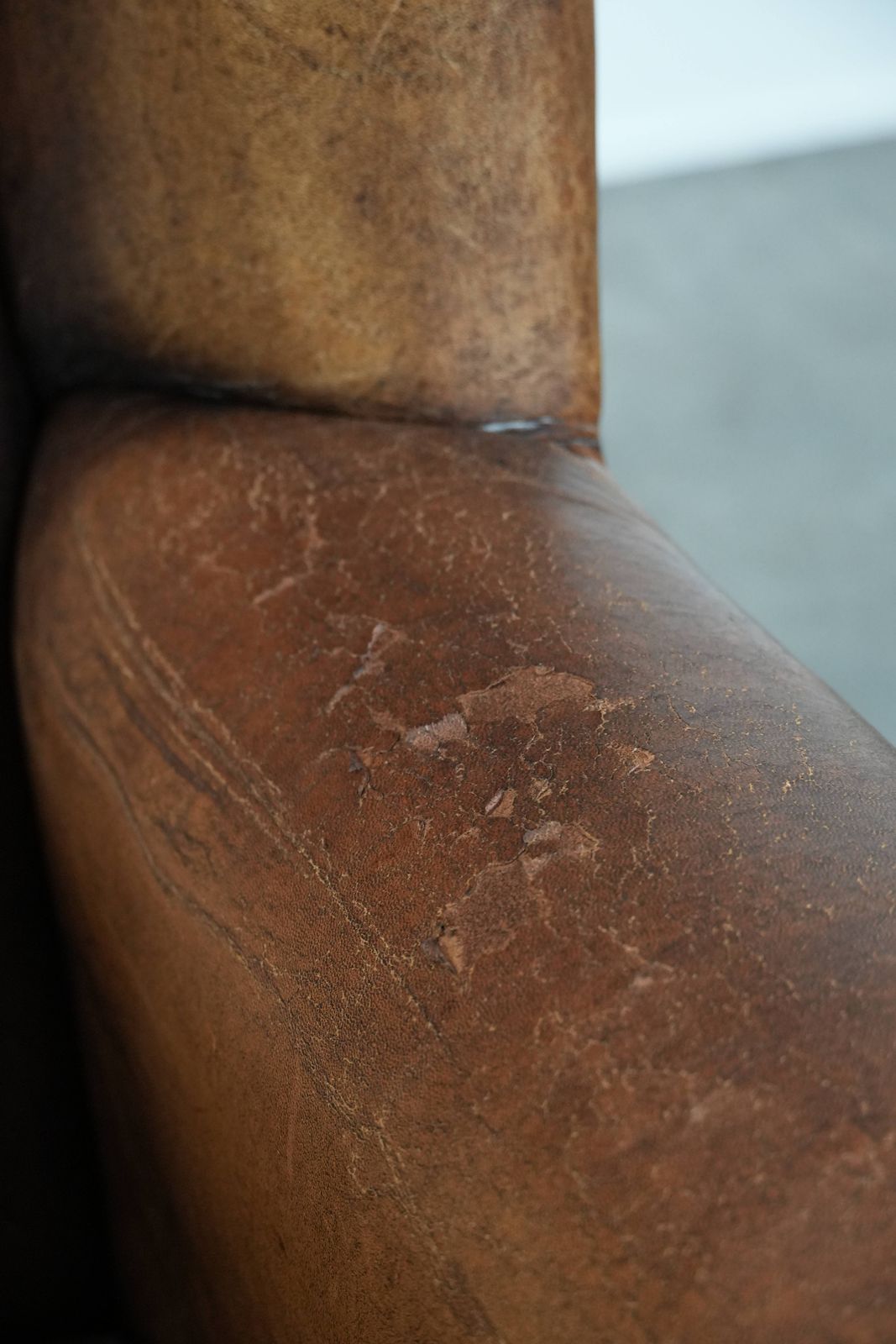 photo furniture Large And Comfortable Sheepskin Wing Chair With A Characterful Look With Black Piping And Decorative Studs