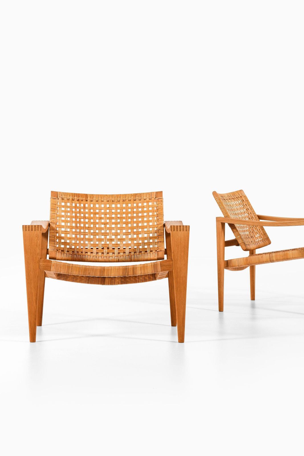 Pair Of Easy Chairs In Oak, Woven Cane, Brass And Leather By Hans Wegner, 1959 photo buy