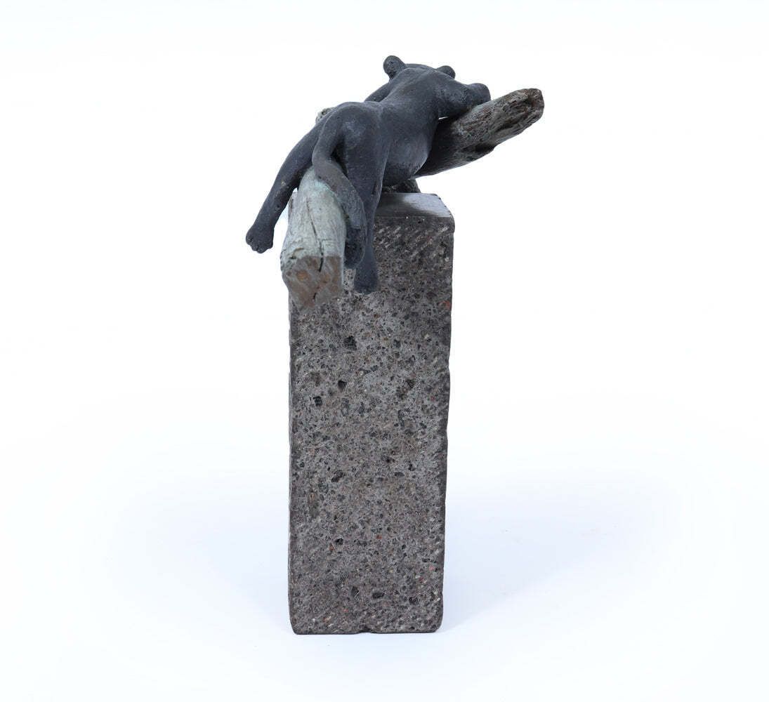 Bronze Sculpture Of A Resting Lioness On Cold Painted Log photo Art